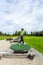 Young teenage boy outdoors at a driving range playing golf and practice his swing.