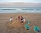 Young teenage boys and girls burying a boy in the sand on the beach in Umhlanga Rocks