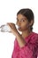 Young teenage girl drinking fresh water from a bottle