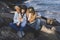 Young teenage girl with her mother in affectionate gesture by the sea. Family vacations on the coast