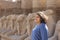Young teenage girl in karnak Temple with sphinx statues in the background in Luxor in Egypt