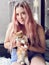 Young teenage girl with long hair holding pet cats