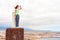 Young teenage girl on mountain peak looking over panoramic view