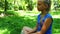 Young teenage girl in a park drinking water