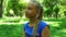 Young teenage girl in a park drinking water