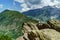 Young teenage girl posing on big stone in Alps