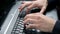 Young, teenaged boy typing on computer keyboard