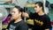 Young teenager applying a hair cream product to straighten the curly hair of his friend