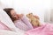 Young Teenager Asleep in Bed with Teddy Bear