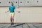 Young teenager boy jumping by the skipping rope on the house roof. Modern people fit challenges concept image