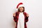 Young teenager celebrates a win, he won a present during Christmas holidays, wearing a Santa hat and red shirt, isolated