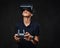 Young teenager dressed in a black t-shirt wears virtual reality glasses and controls the quadcopter using the control