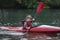 Young teenager girl actively manages a sports kayak boat on a be