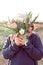 Young teenager girl hiding behind a bunch of tulips. Sunset outdoor scene, family outdoor activity time