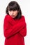 Young Teenager girl with red sweater freezing over isolated background