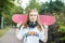 Young teenager girl with a skateboard. Headphones. The concept of an hobby, music and sport