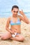 Young teenager girl summer sea beach sunblock sunscreen cream
