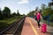 A young teenager from high society, she leaves the provinces on her first vacation trip and waits on the train platform