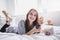 Young teenager watching movies in bed with popcorn