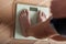 Young teenager weighing himself on a scale