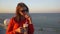 Young teenager woman drinking a frappe on the terrace with a sea view