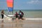 Young teenagers take sailing lessons on small Catamarans