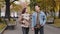 Young teens couple carefree loving partners walking street alley in autumn urban park caucasian man and woman enjoying