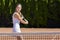 Young tennis athlete ready to return a ball