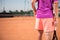 Young tennis player prepares for serving and holding the ball