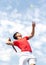 Young tennis player teen with racket hits flying ball in jump and blue sky background. Competitive sports. Copy space