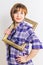 Young thin Woman peers out from the photo frame wearing blue checkered cotton shirt, over white background