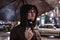 Young thoughtful upset man under umbrella at night. Bad weather