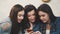 The young three good young girls are sitting in a cafe and spend time communicating