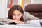 Young tired woman at office desk sleeping with eyes closed, sleep deprivation and stressful life concept