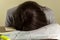 A young tired woman wearing formal dress has fallen a sleep on her office desk while filling federal income tax return forms.