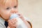 Young toddler boy drinking bottle