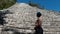 Young tourist admiring the Mayan pyramid of Nohoch Mul, located in the ancient Mayan city of Coba, ideal place for vacation and