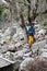 Young tourist boy with camera explore the ancient abandoned Pisidian city Termessos in Turkey