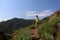 Young tourist boy photographer explore the ruins of ancient abandoned village Gamsutl in Dagestan