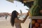 Young tourist buying one of the best juices and smoothies of Marrakech fresh fruit sold in the Jemaa el Fna square