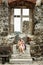 Young tourist caucasian woman posing with ancient window, Visegrad, Hungary