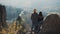 Young tourist couple in love standing on the rocks and enjoy a beautiful view. Man and woman visiting famous tourist