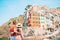 Young tourist couple traveling on european holidays outdoors in italian vacation in Cinque Terre