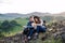 Young tourist couple travellers sitting in nature, resting after hiking.