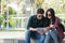 Young tourist couple uses their Tablet to find routes through an app at the entrance of a subway station