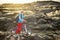 Young tourist cycling on lava field on Hawaii. Female hiker heading to lava viewing area at Kalapana on her bike. Tourist on hike
