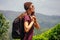 Young tourist girl with a backpack enjoying a good morning in tea plantations in India Munnar Kerala