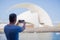 Young tourist male looking at the view and taking photos of landmarks in Tenerife, Spain