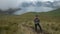 Young tourist man walking with trekking poles near the Mojanda lagoon