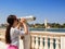 Young tourist observes the Brindisi coast with binoculars